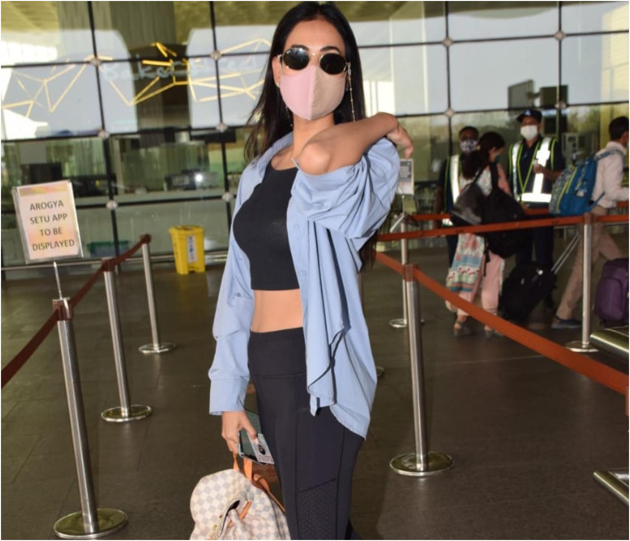 Sonal Chauhan was snapped at the Mumbai Airport. The actress increased the city's temperature in her black crop top, pants and blue shirt.