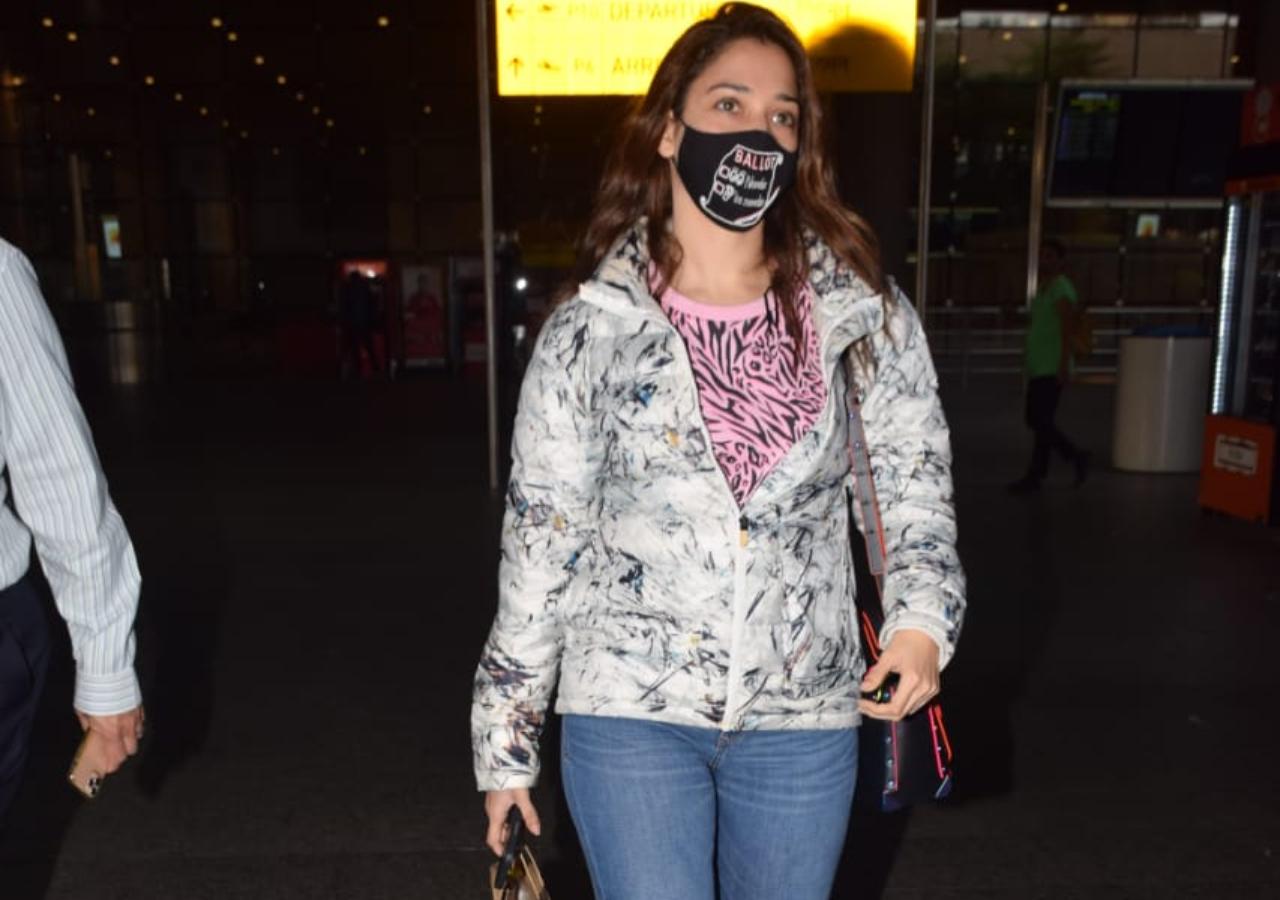 Tamannaah Bhatia wore a pink printed top, white jacket and denims as she was snapped at the airport.
