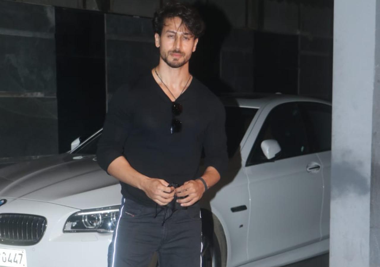 Tiger Shroff showed off his muscles in his black t-shirt and grey shorts when clicked by photographers.