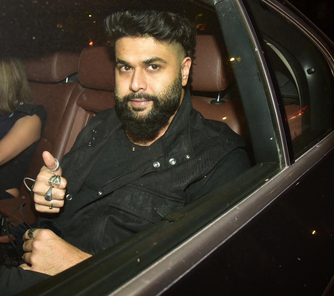 Popular Bollywood fashion designer Kunal Rawal posed for the paparazzi as he attended Varun Dhawan's wedding party.
 