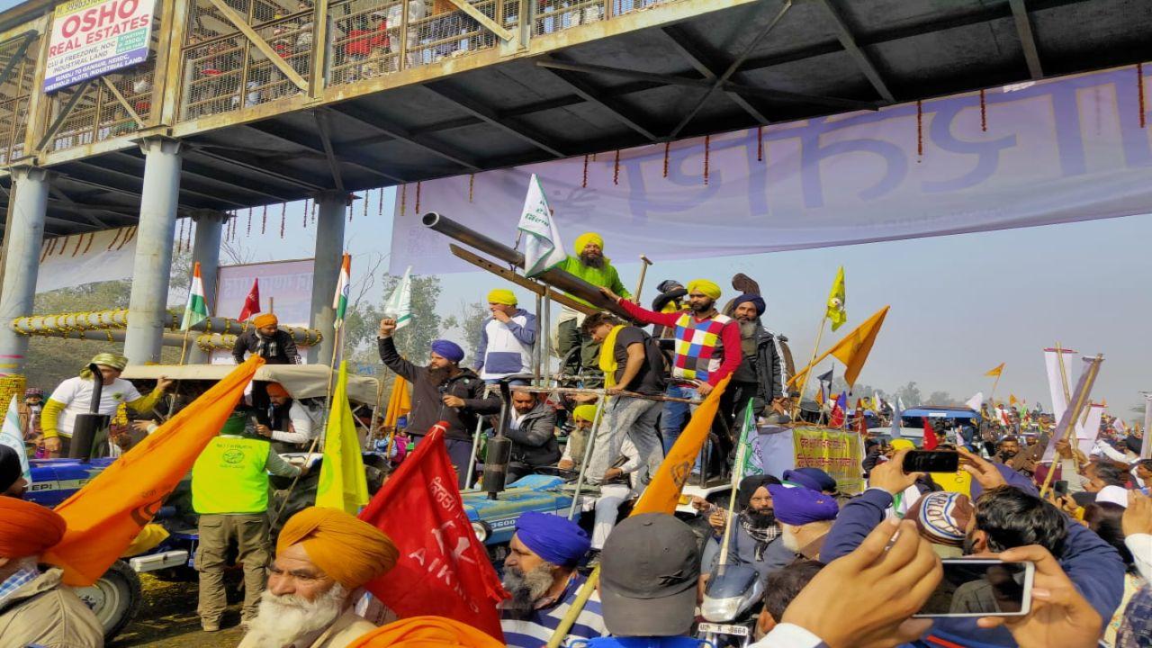 Protesters climb atop tractor during the rally in New Delhi. Pic/Diwakar Sharma