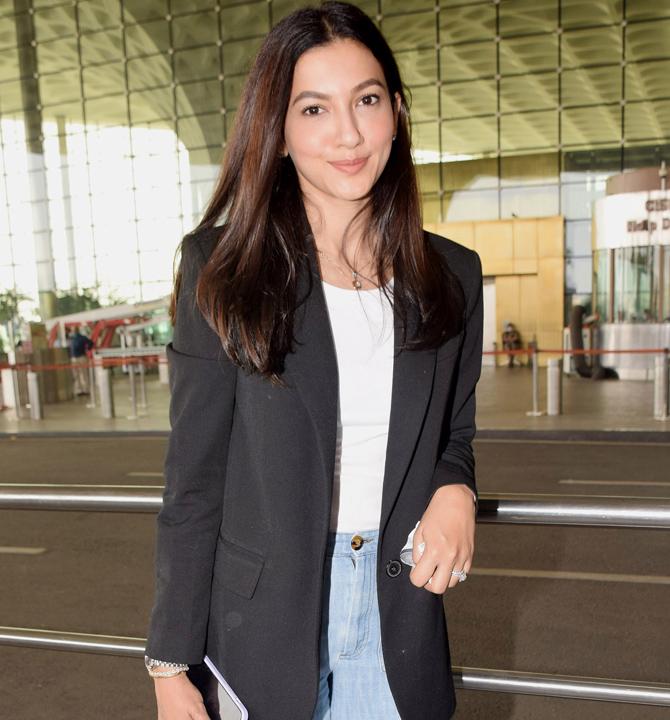 Gauahar Khan, who recently got married to Zaid Darbar, was clicked at Mumbai Airport. The actress was all smiles for the paparazzi, stationed outside the airport. She opted for a white tee, blue loose denims and black blazer as her airport look.