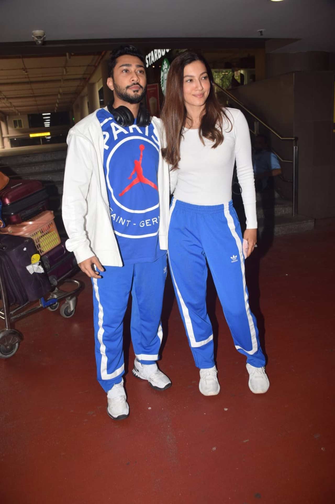 Gauahar Khan and Zaid Darbar posed for the shutterbugs when snapped at the Mumbai airport. The duo was clicked twinning in a white and blue outfit as they headed towards the airport. Gauahar Khan and Zaid Darbar posed for the shutterbugs when snapped at the Mumbai airport. The duo was clicked twinning in a white and blue outfit as they headed towards the airport.