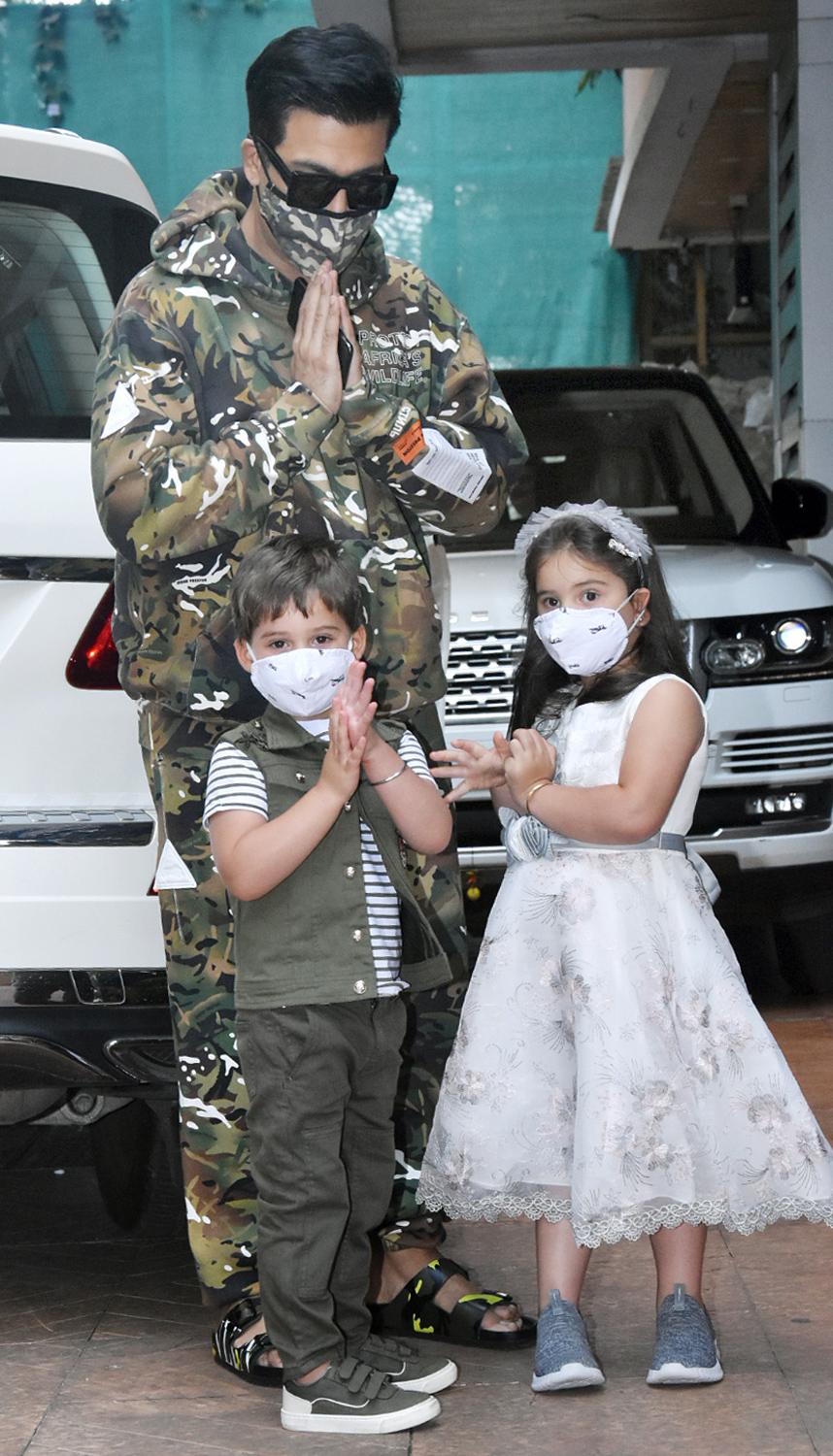 Karan Johar, who too welcomed Yash and Roohi via surrogacy, posed with the twins. The trio was all smiles when snapped by the paparazzi at the bash.