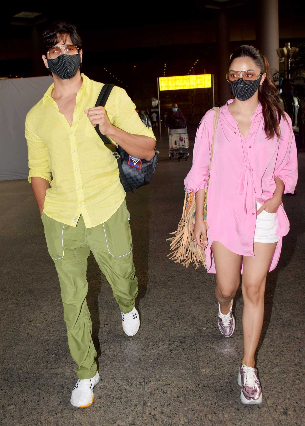Kiara Advani was seen wearing a pretty pink shirt dress, paired with white shorts. She completed her airport look with pink metallic shoes.