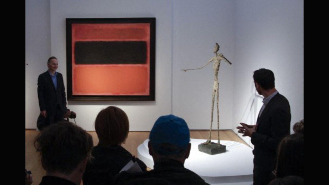 People looking at Giacometti's 'L'homme au doigt' during a media preview on May 1, 2015, at Christie's in New York. That year, the bronze sculpture made in 1947 became one of the most expensive sculptures to be sold at an auction. Photo: AFP