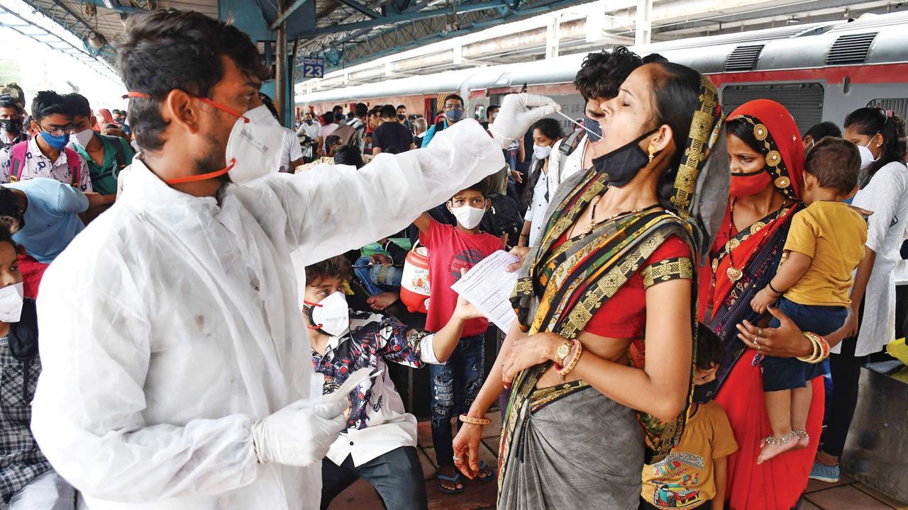 Civic health workers conduct Covid tests for arriving passengers at Dadar station on Sunday. Pic/Ashish Raje