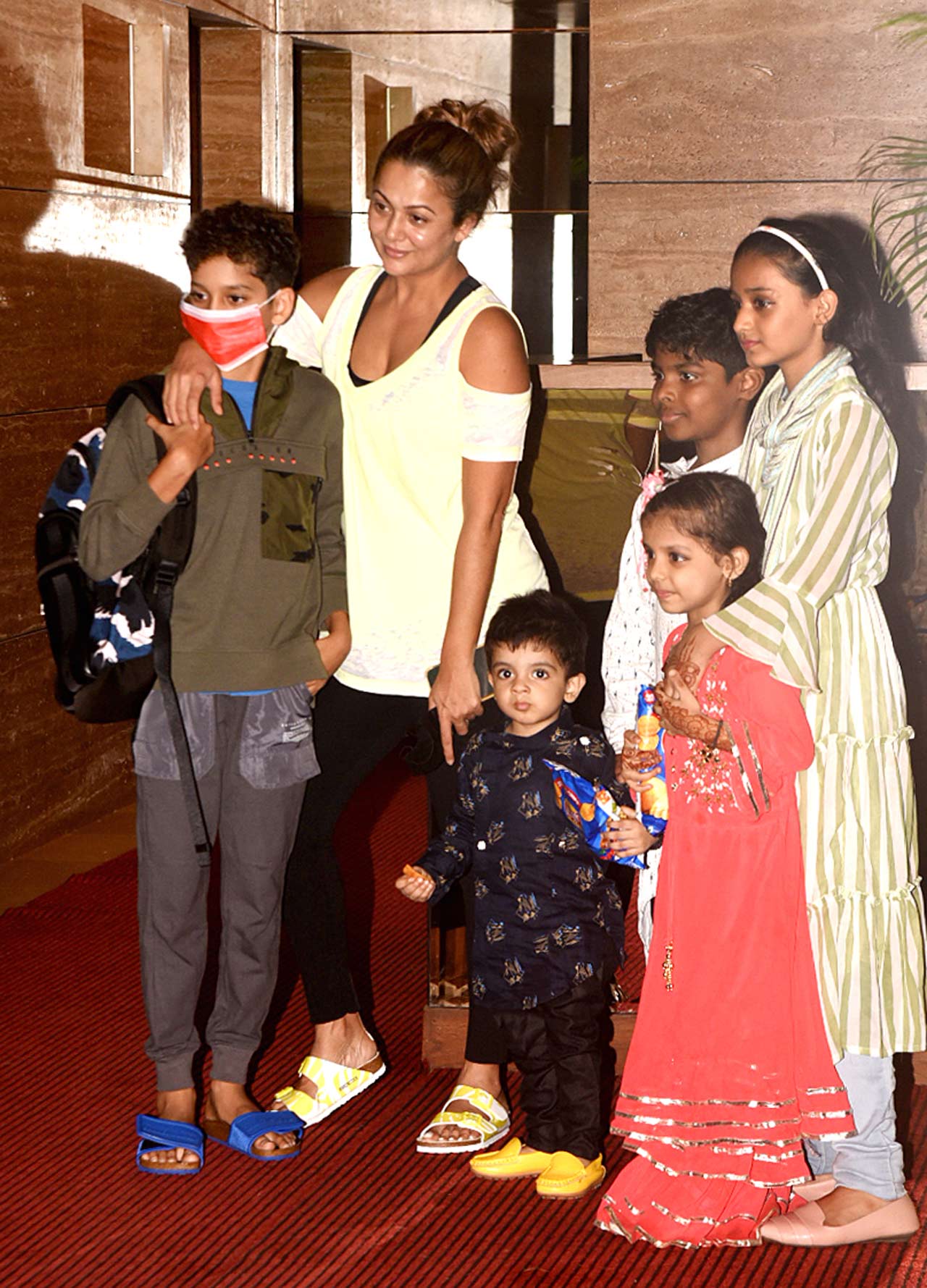 Amrita Arora was snapped with her kids at Malaika Arora's Bandra residence. The actress sported a white cold-shoulder top, paired with a basic pair of denim in the city.