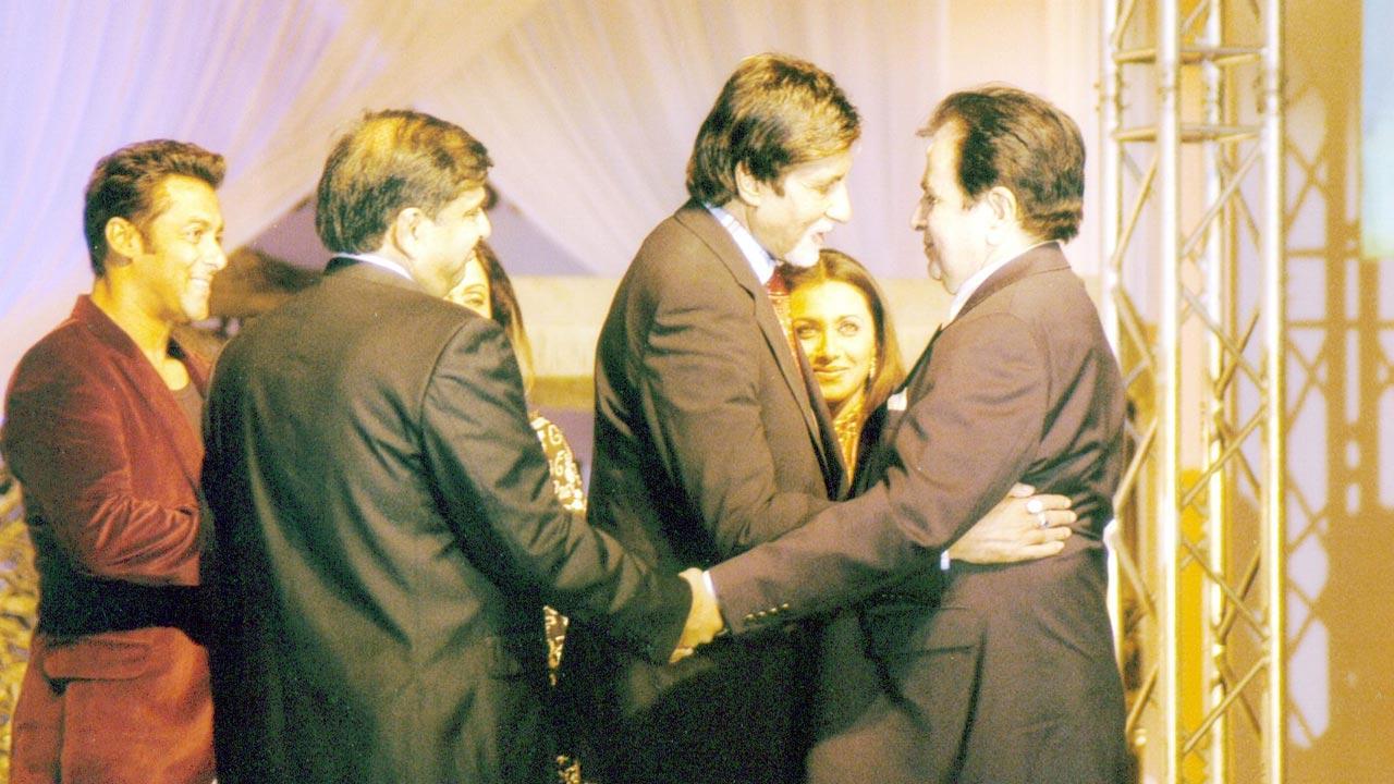 Dilip Kumar receives a warm hug from Amitabh Bachchan at an awards function. Salman Khan and Rani Mukerji too can be seen sharing the stage