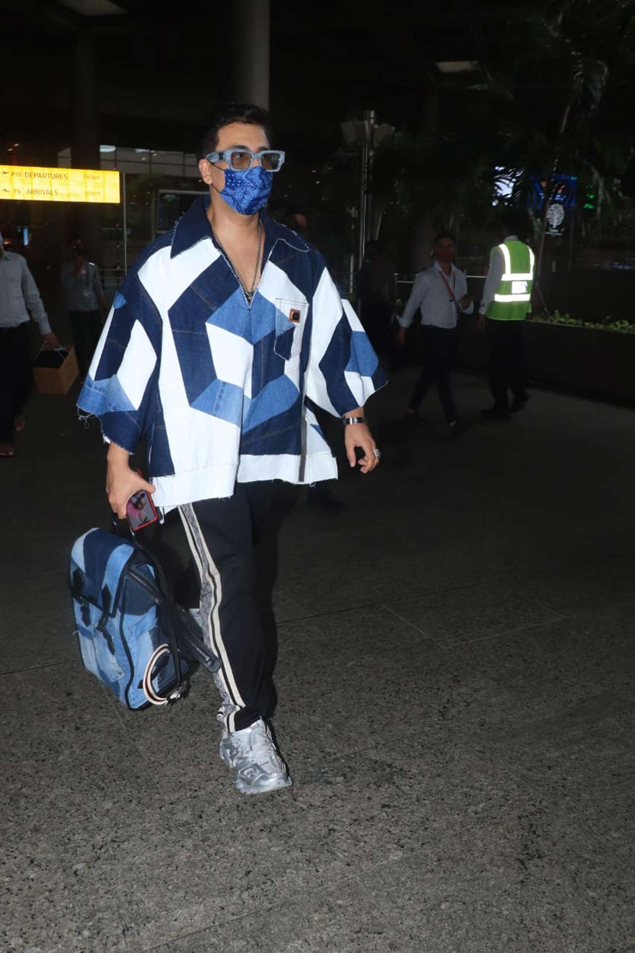 Karan Johar showed off his quirky fashion was clicked at the Mumbai airport. The popular director opted for an oversized block-coloured jacket, paired with a black basic tee and denim during the outing.