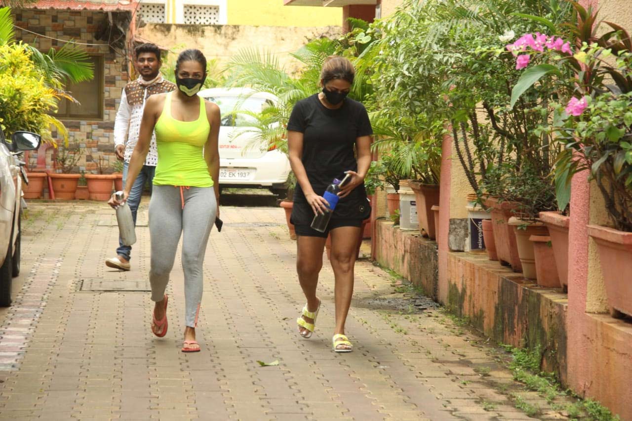 Malaika Arora was snapped with sister Amrita at a yoga studio in Bandra, Mumbai. The fitness diva stunned in a neon tank top which she paired with grey track pants for her workout session. Speaking of Amrita, the actress sported all-black gym wear.