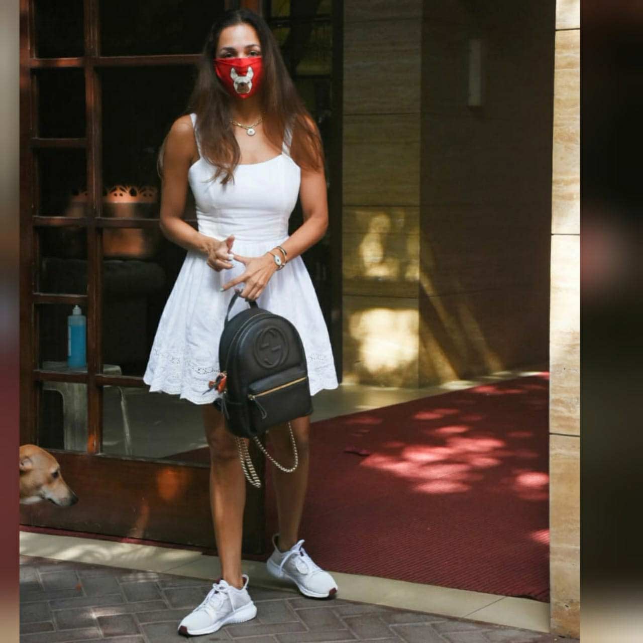 Malaika Arora opted for a white dress paired with sneakers when snapped in Bandra, Mumbai. She completed her casual look with a black backpack and minimal makeup.