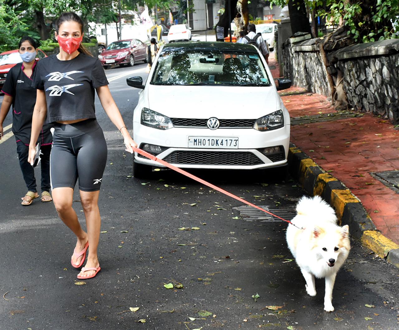 Malaika Arora was spotted outside her residence in Bandra, Mumbai. The actress stepped out to walk her pet dog, Casper. Malaika opted for an all-black athleisure, looking every bit fit and fab.