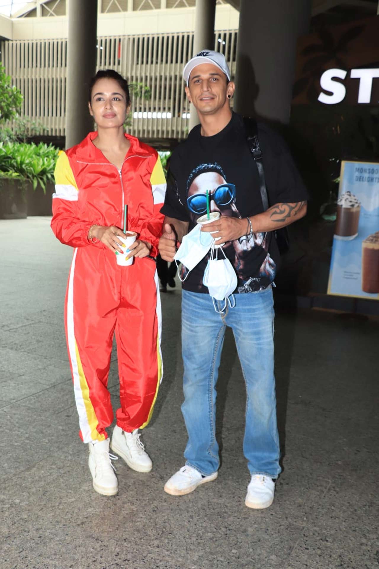 Yuvika Chaudhary and Prince Narula posed for the shutterbugs when snapped at the Mumbai airport. The actress opted for a red coloured tracksuit, and Prince was seen wearing a basic black tee paired with denim.
