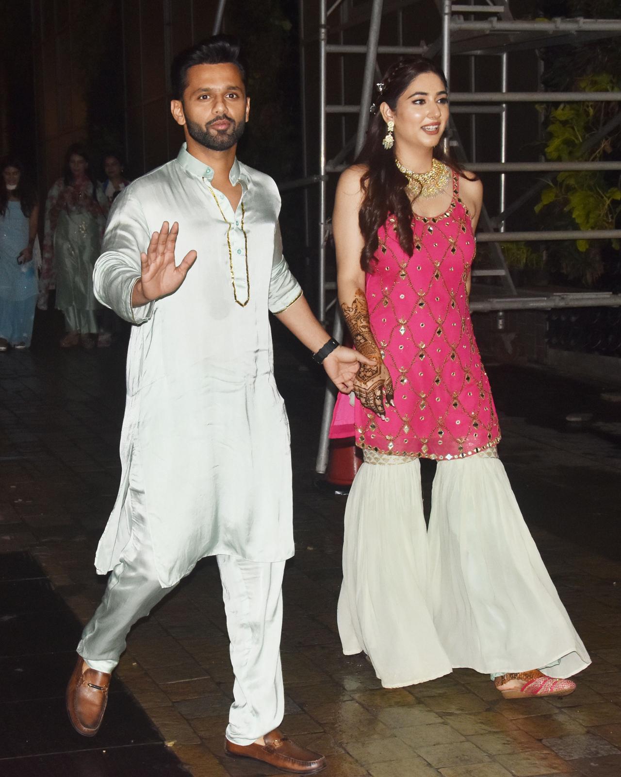 Rahul Vaidya and Disha Parmar were all smiles as they were photographed outside the latter's residence in Four Bungalows, Mumbai. The bride-to-be looking absolutely gorgeous in a bright pink and pastel green sharara, while the singer was seen in light blue kurta-pyjama, paired with loafers.