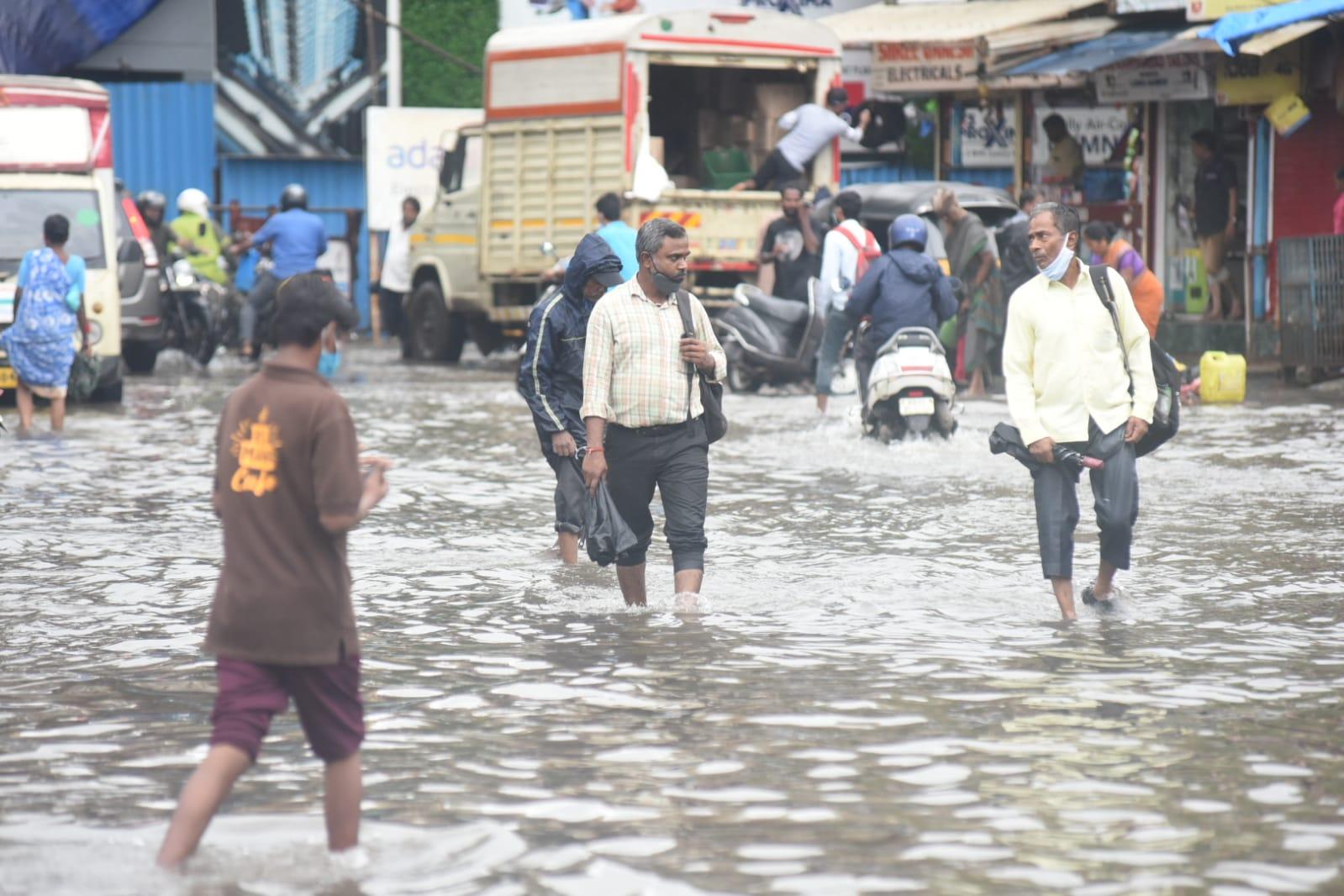 People walk on a water-logged road near Kurla (East) station. Pic/ Sameer Markhende