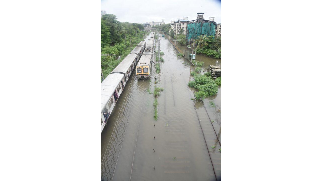 A local train amid water logging on tracks at Kurla (East) station. Pic/ Sameer Markhende