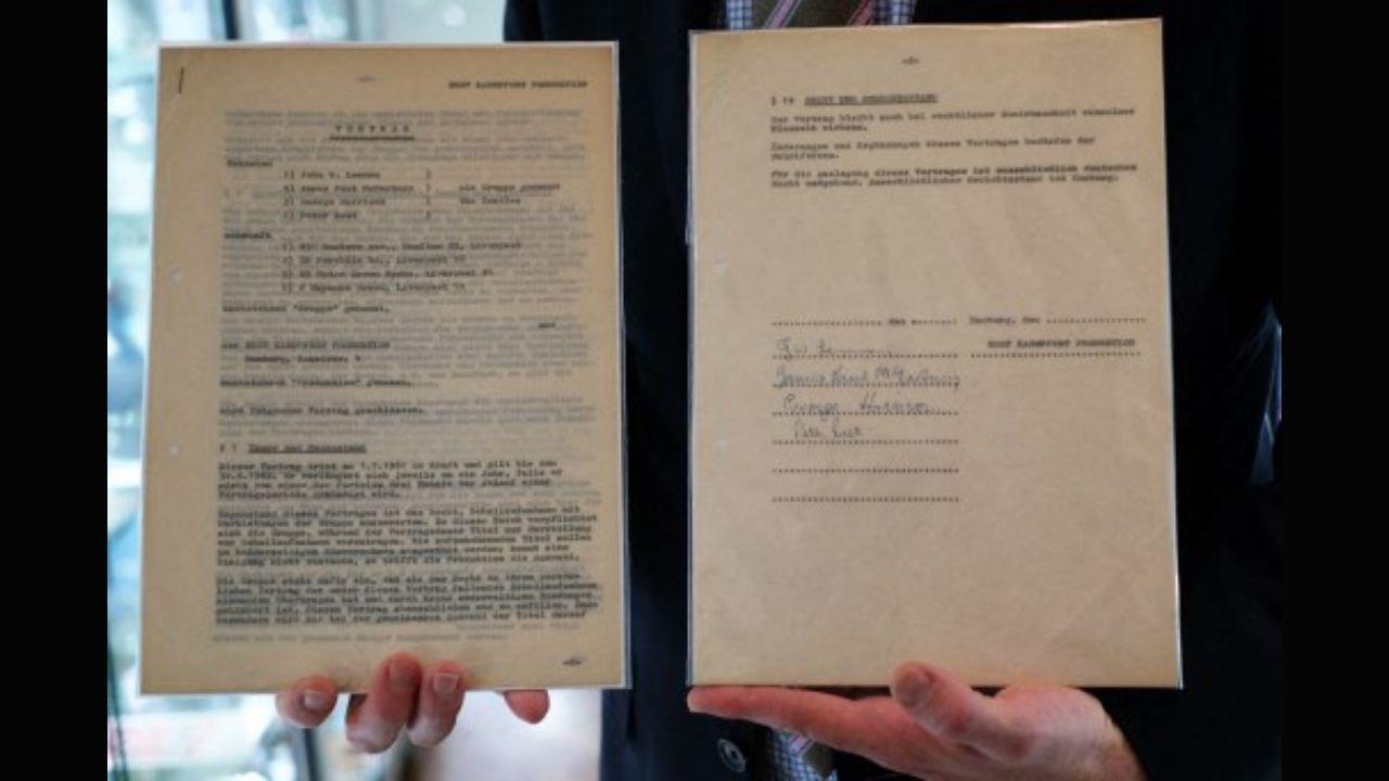 Dean Harmeyer from Heritage Auctions displays the first ever recording contract signed by The Beatles, for the 