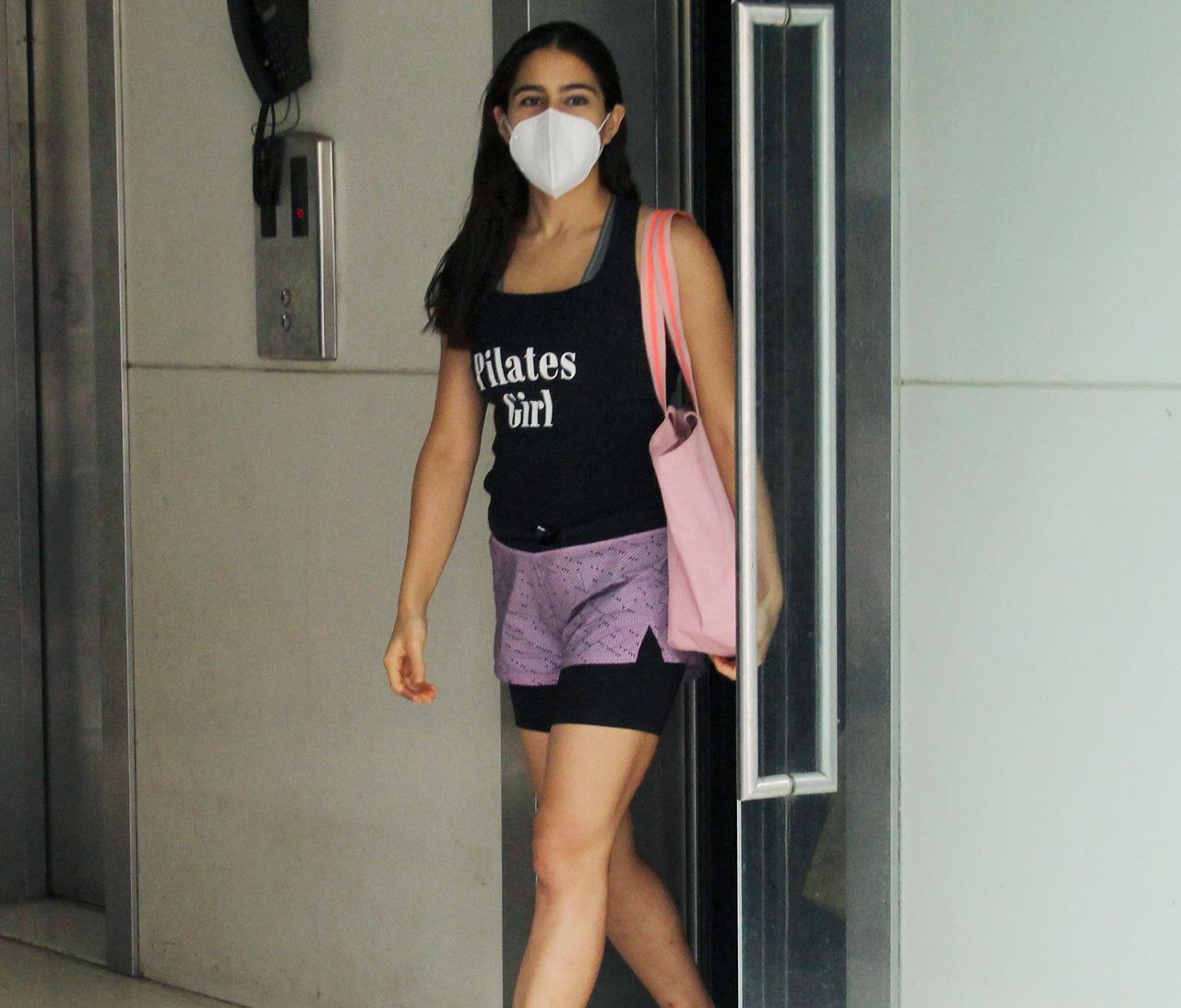 Sara Ali Khan sported a black tank top and dual coloured gym shorts as she was seen leaving her fitness studio in Bandra. Sara is, without a doubt, a 'Pilates Girl'! Going by her statement on her tank top.