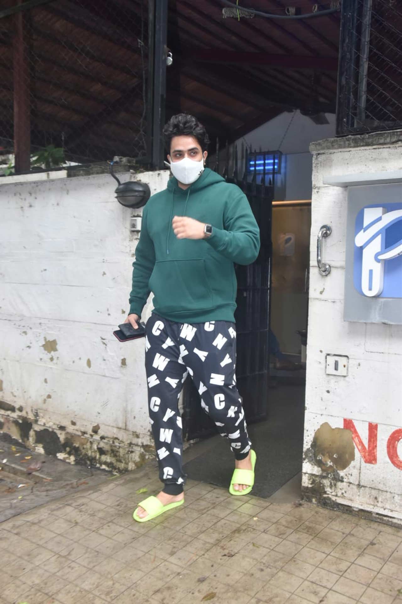 Aly Goni was clicked outside a clinic in Juhu, Mumbai. Aly was clad in a green sweatshirt and funky print track pant teamed up with florescent colour flip-flops. Aly Goni was clicked outside a clinic in Juhu, Mumbai. Aly was clad in a green sweatshirt and funky print track pant teamed up with florescent colour flip-flops.