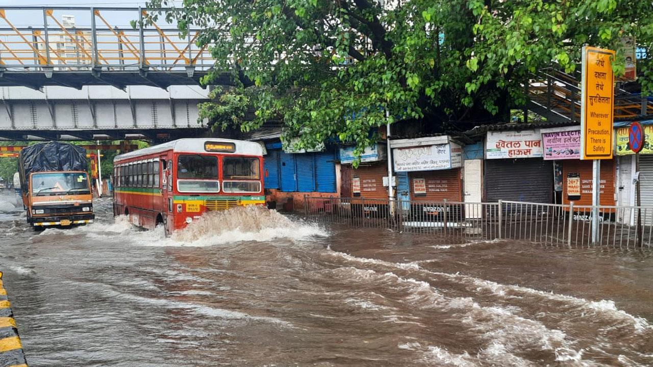Mumbai rains: Heavy downpour disrupts local train, bus services in city A BEST bus move through a flooded street in Sion. Photo: Pradip Dhivar