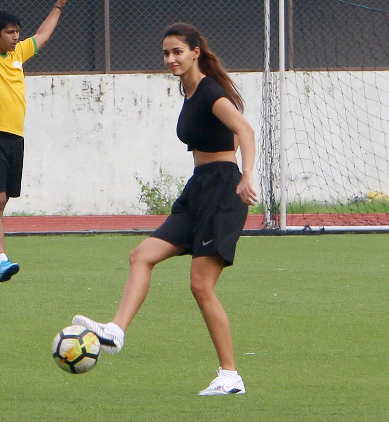 Disha Patani snapped in between her game. The actress opted for a black t-shirt, which she tied in a knot and paired with black shorts and white studs.