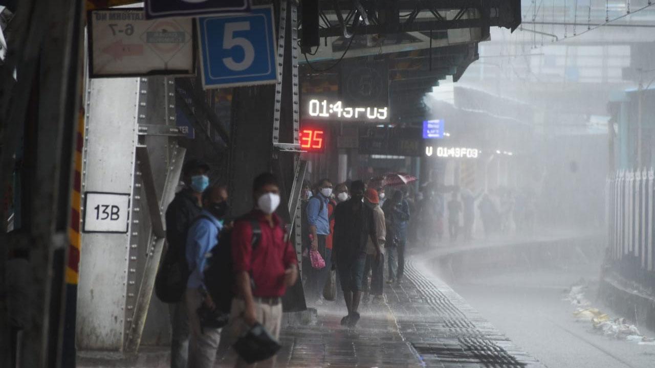 Commuters wait for local trains at Dadar station amid heavy downpour in the city. Local train services on Central and Harbour line in Mumbai were suspended in the morning due to waterlogging on the railway tracks. Photo: Ashish Raje