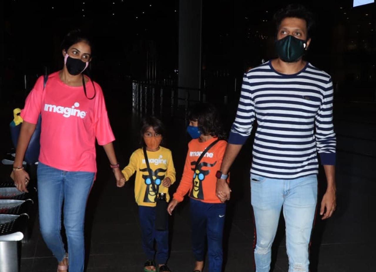 Riteish Deshmukh, Genelia Deshmukh were clicked at Mumbai airport, along with their kids, Riaan Deshmukh and Rahyl Deshmukh. The couple opted for casuals - denim and t-shirt, while their sons were clad in similar printed tees but in different colours.
