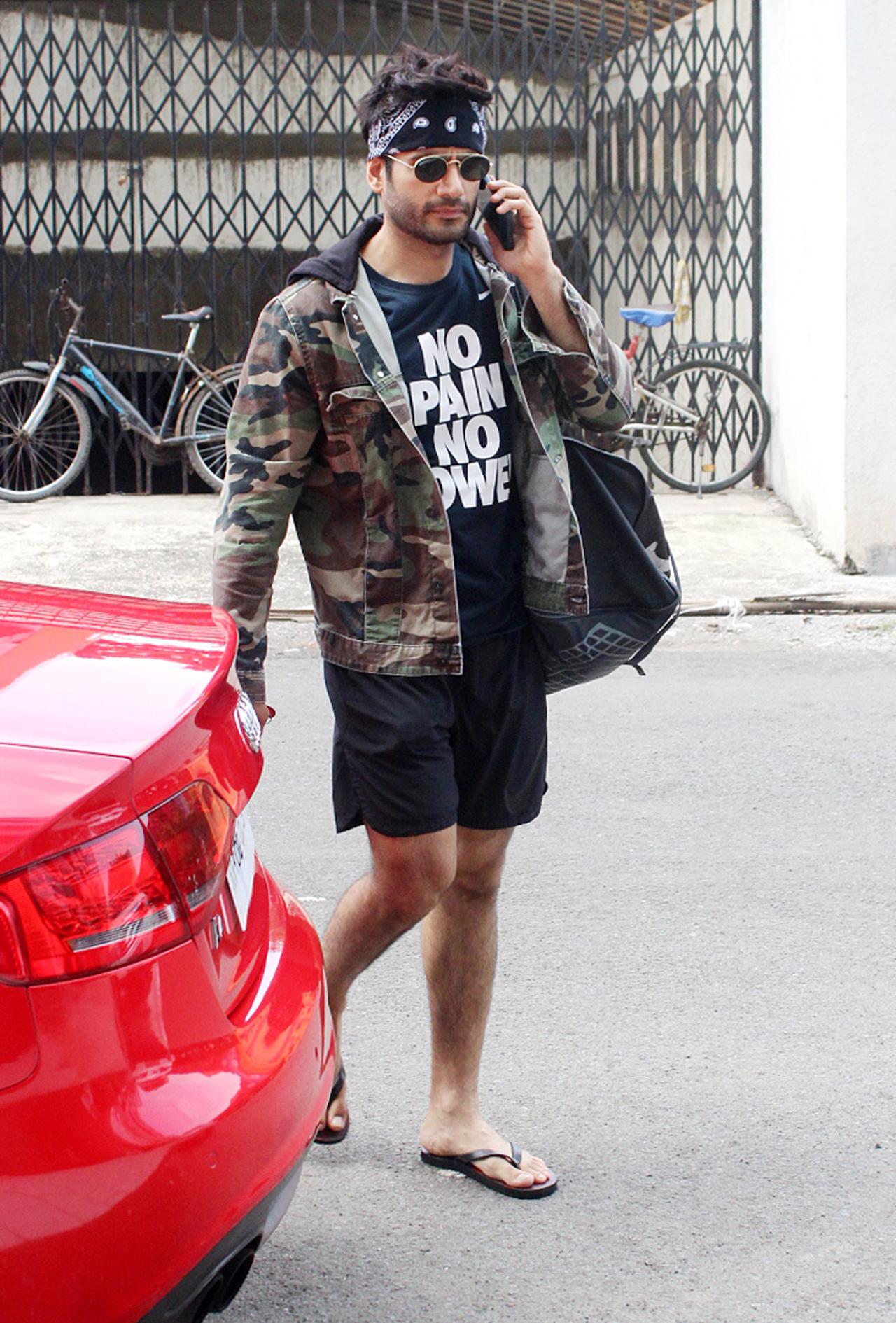 Karan Tacker was also snapped outside his gym, in Andheri, Mumbai. The `Special Ops` actor kept it stylish, as he was seen in a black t-shirt and shorts, paired with a camouflage-print jacket. He completed his look by sporting a bandana and black sunglasses.  Karan Tacker was also snapped outside his gym, in Andheri, Mumbai. The `Special Ops` actor kept it stylish, as he was seen in a black t-shirt and shorts, paired with a camouflage-print jacket. He completed his look by sporting a bandana and black sunglasses. 