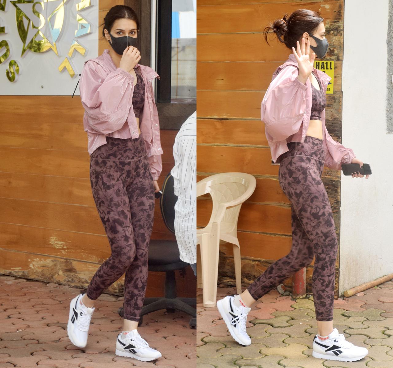 Kriti Sanon was snapped outside her dance class in Andheri, Mumbai. Kriti sizzled in a mauve printed bralette and leggings with a pink jacket thrown over. The actress was heading home, after attending the dance classes.