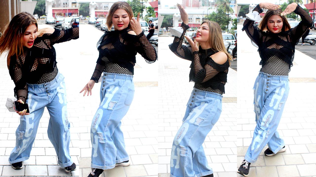 Rakhi Sawant was clicked outside a gym in Andheri, Mumbai. The actress, as can be seen in the pictures, danced her heart out in front of the paparazzi. We wonder the reason behind this happy dance! Rakhi Sawant was clicked outside a gym in Andheri, Mumbai. The actress, as can be seen in the pictures, danced her heart out in front of the paparazzi. We wonder the reason behind this happy dance!