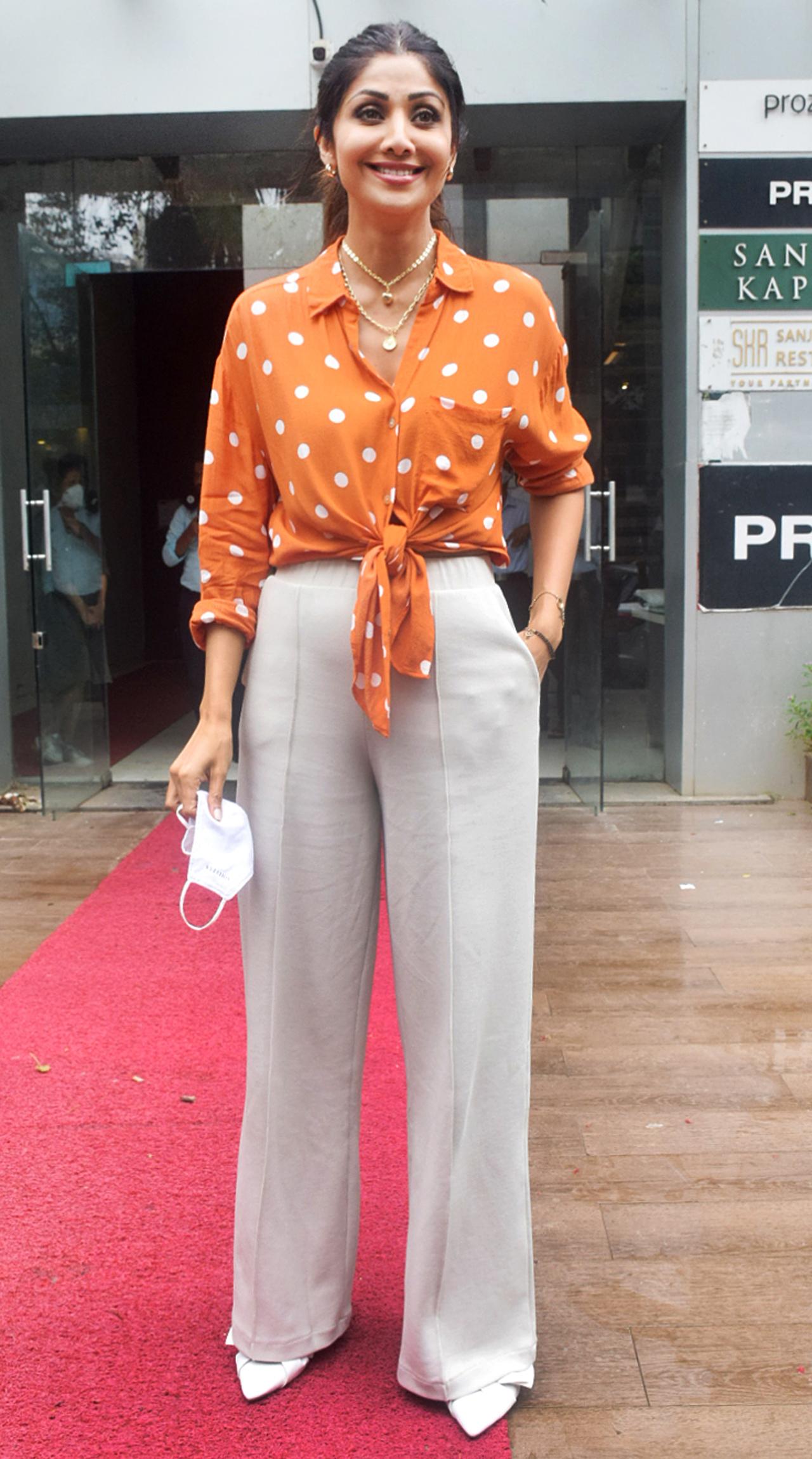 Shilpa Shetty was snapped in Andheri, in her stylish best. The actress opted for an orange with white polka dots shirt that she tied up, paired with a high-waisted beige trouser. As usual, Shilpa was all smiles for the paparazzi. Shilpa Shetty was snapped in Andheri, in her stylish best. The actress opted for an orange with white polka dots shirt that she tied up, paired with a high-waisted beige trouser. As usual, Shilpa was all smiles for the paparazzi.