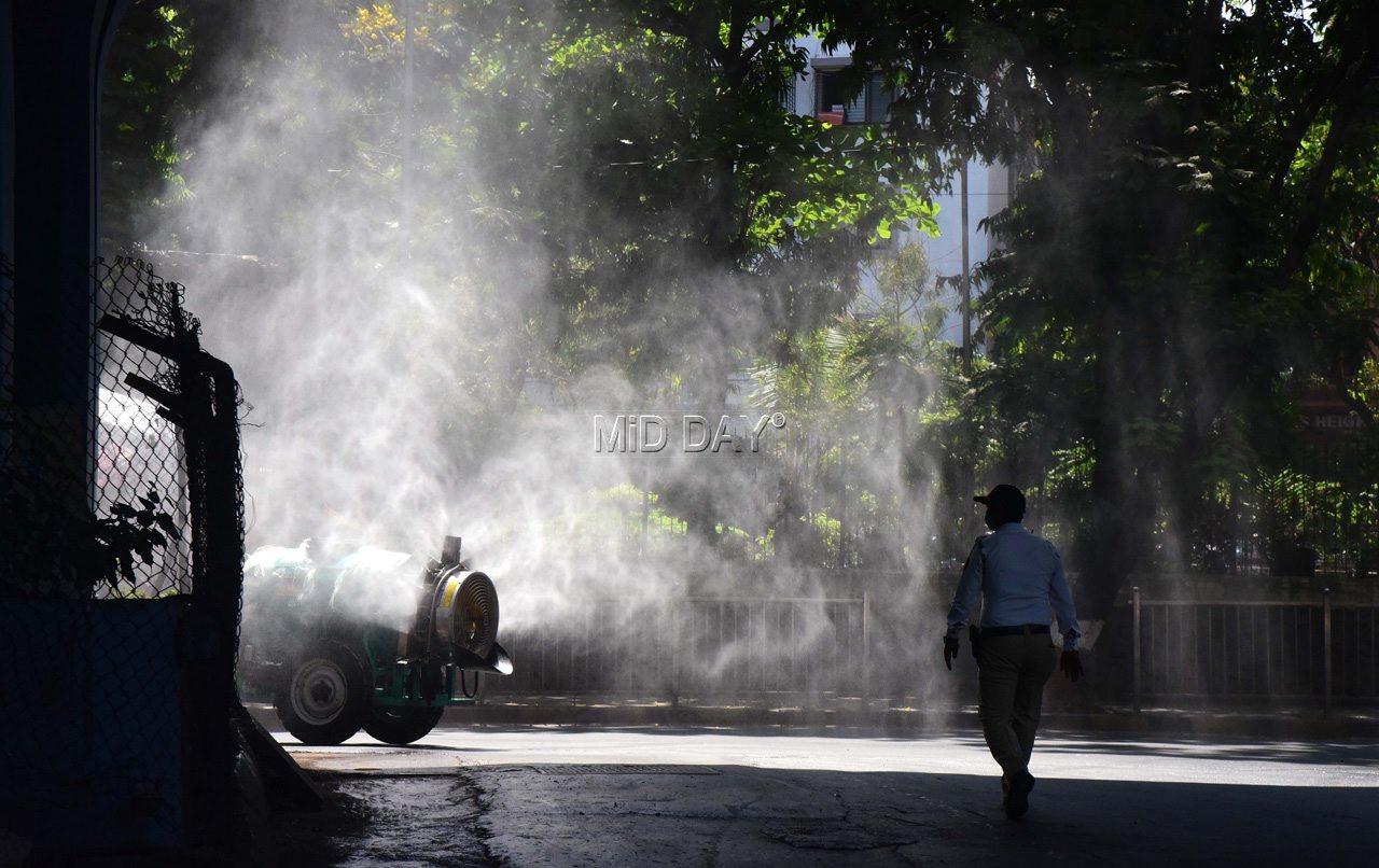 Mumbai Fire brigade personnel disinfecting a traffic police chowki and the surrounding area of Sion Hospital on April 1, 2020. PIC/ SURESH KARKERA