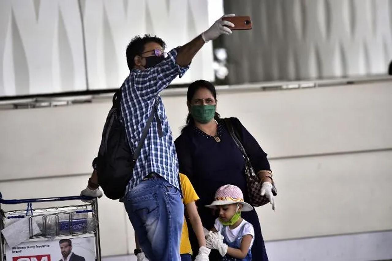 As soon as domestic flight services resumed, there was a surge in the number of travellers flying back to their homes from the Mumbai Airport.
In pic: A family poses for a selfie before catching a flight.