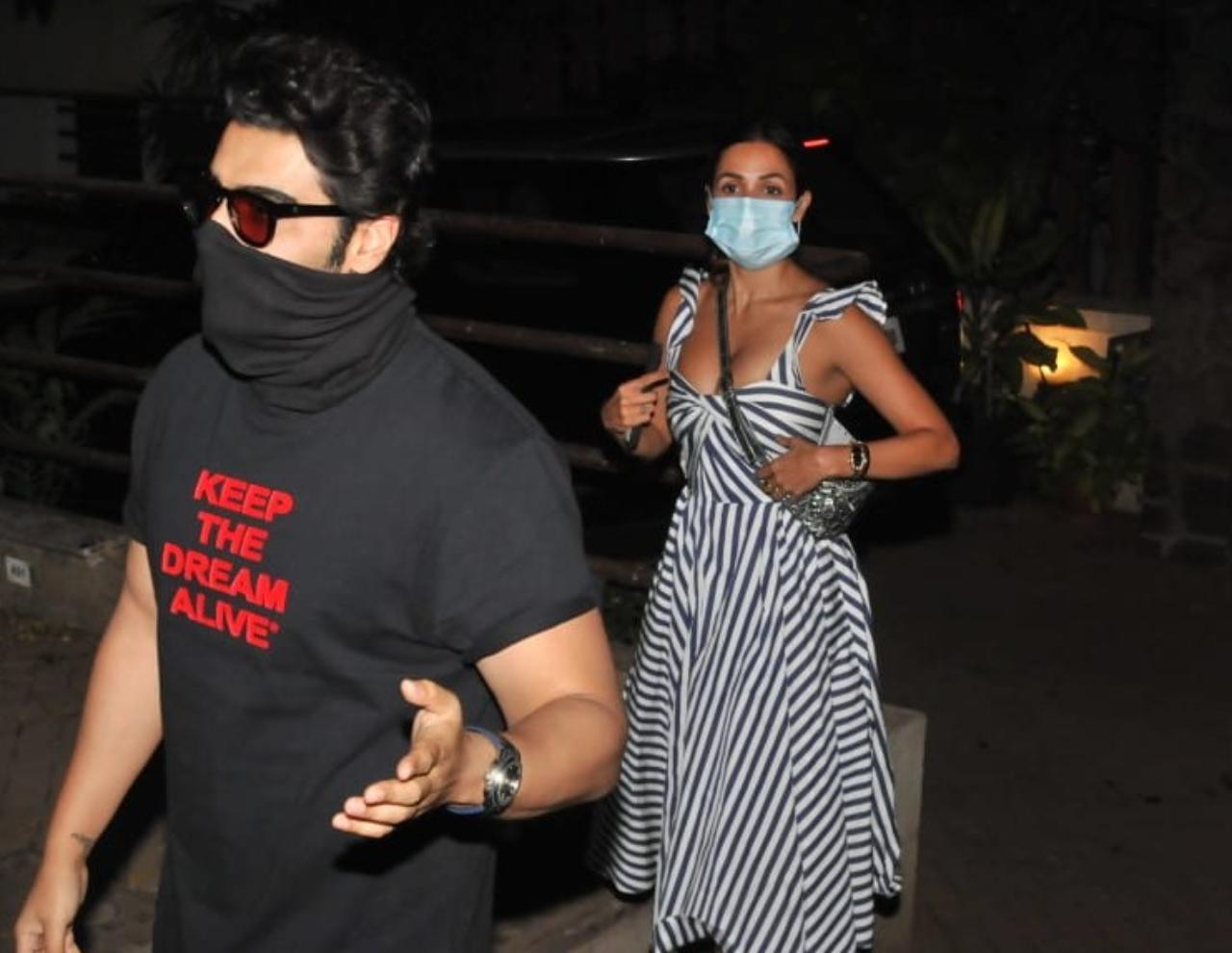 Malaika Arora was clicked with her boyfriend Arjun Kapoor. Malaika looked chic in her white checkered dress while Arjun opted for a black t-shirt and jeans for the outing.