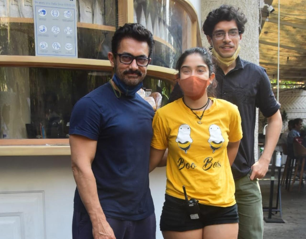 Aamir Khan was snapped by the photographers enjoying a family lunch in Bandra, Mumbai. The actor was spotted with his daughter Ira Khan and son Junaid Khan. They were all smiles posing for the shutterbugs present there. While Aamir looked handsome in his casual t-shirt and pants, Ira looked cute in her yellow t-shirt and black shorts. (All pictures: Yogen Shah).