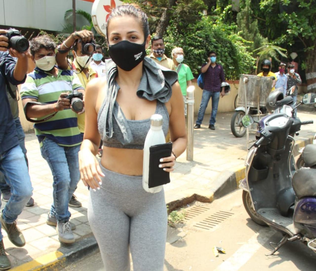 Malaika Arora showed off her well-built physique as she was snapped by the photographers outside her gym in Bandra, Mumbai. The 47-year-old star looked chic in her grey sports bra and trousers. She wore a black mask to prevent the spread of COVID-19. (All pictures: Yogen Shah).