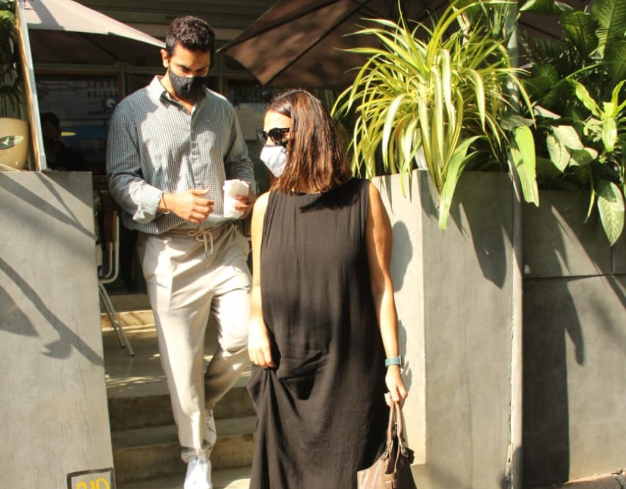 Neha Dhupia and Angad Bedi were snapped enjoying a romantic lunch at a popular restaurant in Bandra, Mumbai. For the outing, Neha opted for a black dress while Angad donned a green shirt and pants for the outing. (All pictures: Yogen Shah).