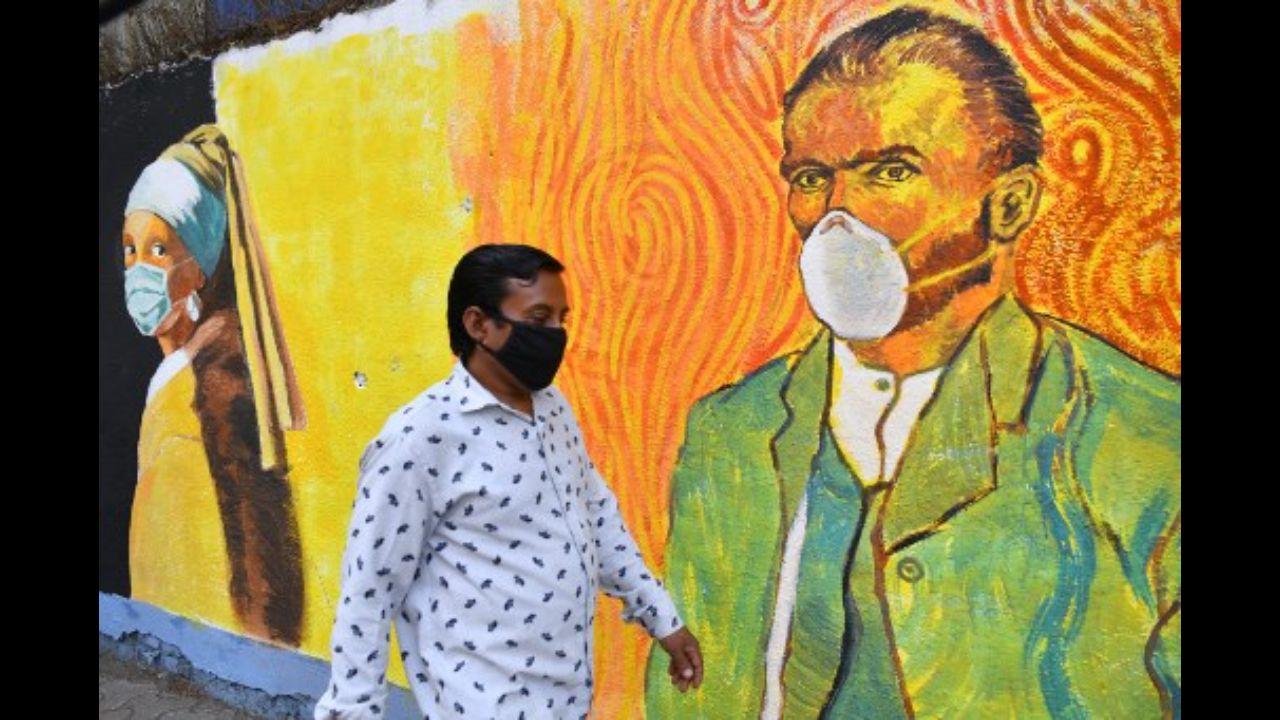 In these murals, Vincent Van Gogh's self-portrait and Johannes Vermeer's famous 'Girl with a Pearl Earring' appear with masks, as a safety reminder for Covid-19. Photographed in Mumbai on March 10, 2021.
Photo: AFP