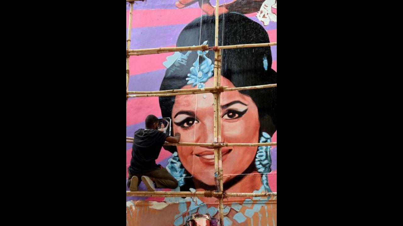 An artist puts finishing touches on a wall mural of Bollywood actress Asha Parekh on a residential building in Mumbai on May 14.
Photo: AFP