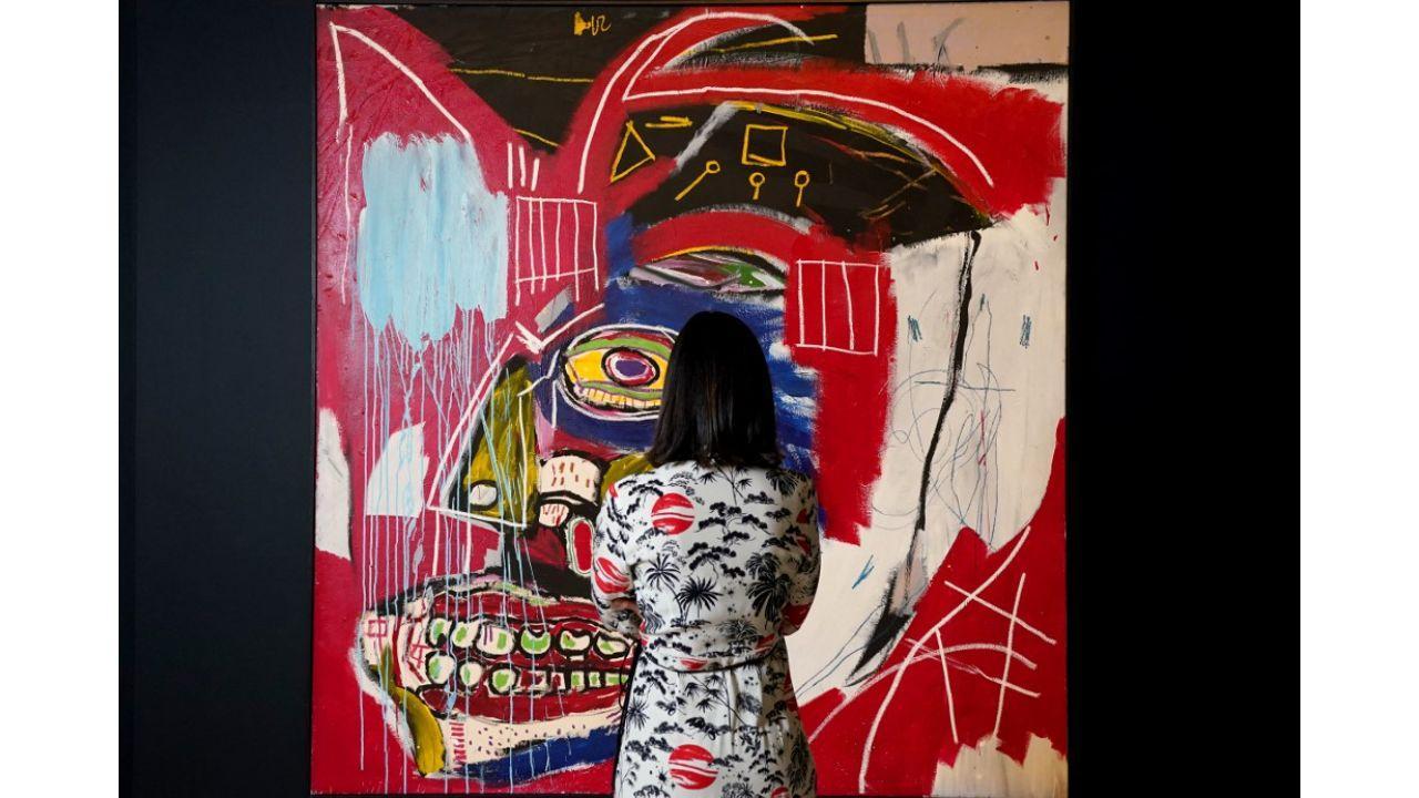 A woman looking at Jean-Michel Basquiat's ‘In This Case’ (1983) ahead of Christie's 20th and 21st Century Evening Sales in New York. It sold for $93.1 million on May 11, 2021.