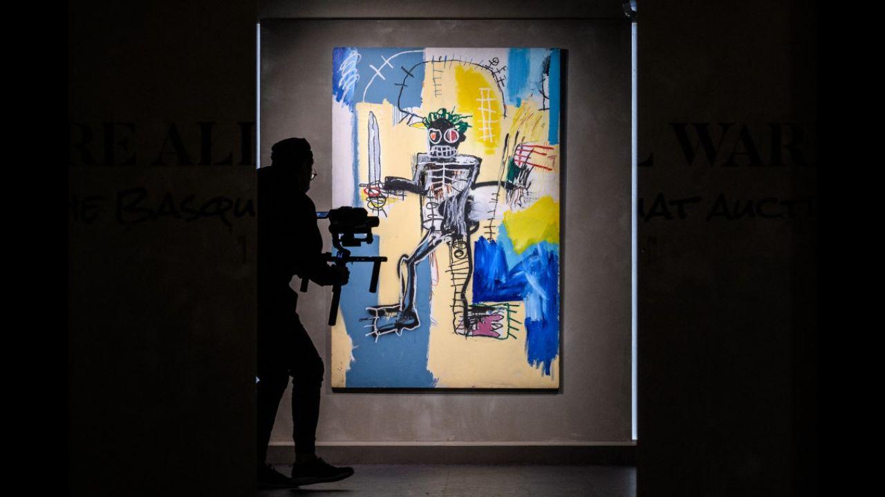 A cameraman walks past US artist Jean-Michel Basquiat's 1982 painting, 'Warrior' at the Christies auction house showroom in Hong Kong on March 22, 2021.
Photo: Anthony Wallace / AFP
