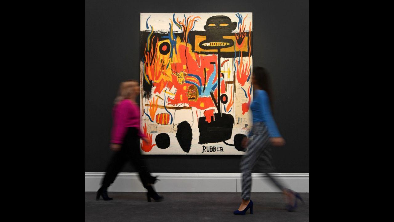 Gallery assistants pose next to an artwork entitled 'Rubber' 1985, by US artist Jean-Michel Basquiat, during a photo call at Sotheby's Galleries in central London on February 7, 2020.
Photo: Daniel Leal-Olivas / AFP