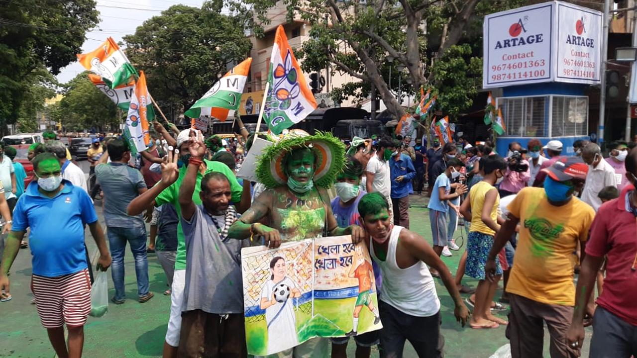 A group of Trinamool Congress (TMC) party workers sans face mask pose for a picture while flouting COVID-19 guidelines as they celebrate the party's landslide victory in the West Bengal Assembly Elections. Photo/Pallav Paliwal