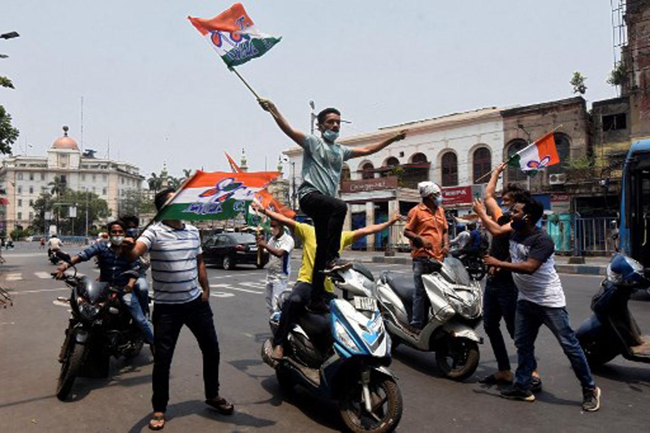 Supporters of the Trinamool Congress (TMC) party violate COVID-19 norms and traffic rules as they celebrate their party's lead in the West Bengal state legislative assembly elections in Kolkata. Photo/AFP
