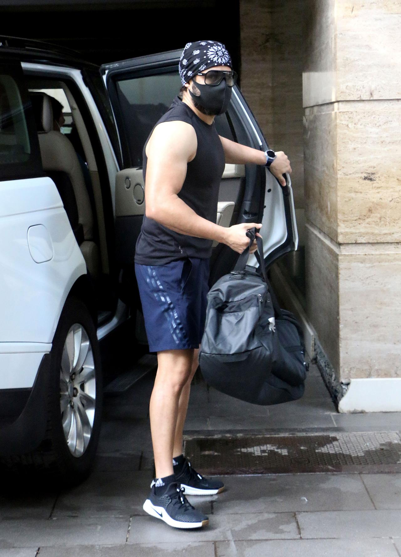 Emraan Hashmi was clicked in Bandra, Mumbai. The actor wore a black vest and blue shorts and also donned a printed bandana and a face mask as a precautionary measure.