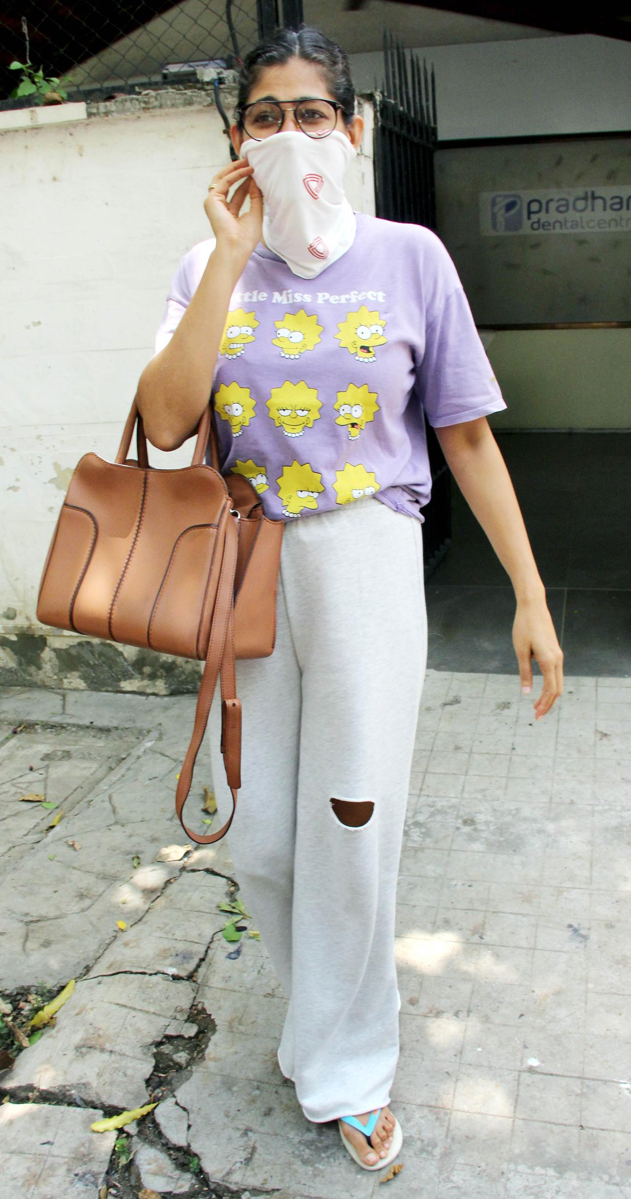 Kubbra Sait was spotted outside a clinic in Juhu, Mumbai. The 'Sacred Games' actress sported a super cute purple Lisa Simpson t-shirt, paired with a white track pant and turned a bandana into a mask.
