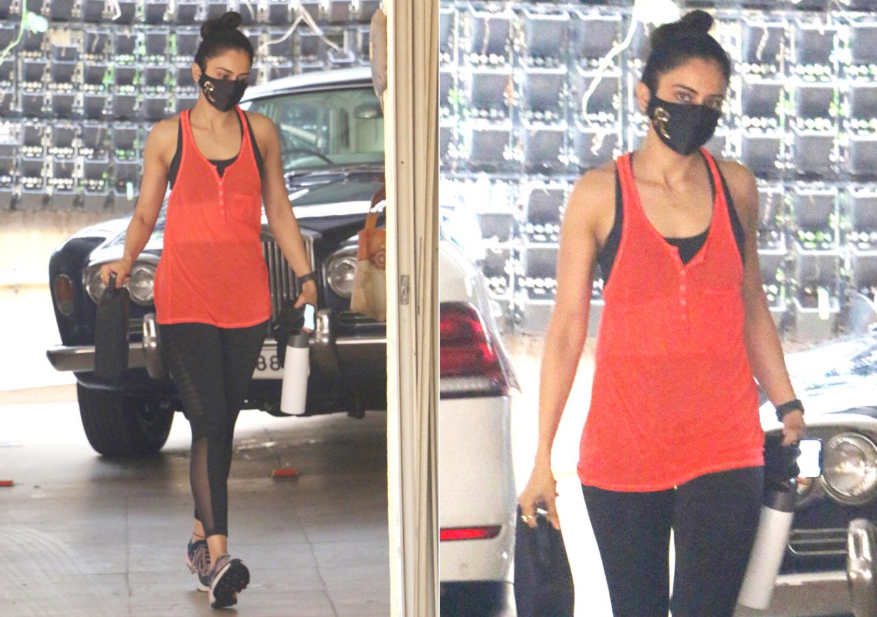 Rakul Preet Singh was clicked outside her residence in Mumbai. The actress, whose film 'Sardar Ka Grandson' released recently on Netflix, was seen in an orange tank top, paired with black yoga pants, hair tied in a bun and of course, masked up.