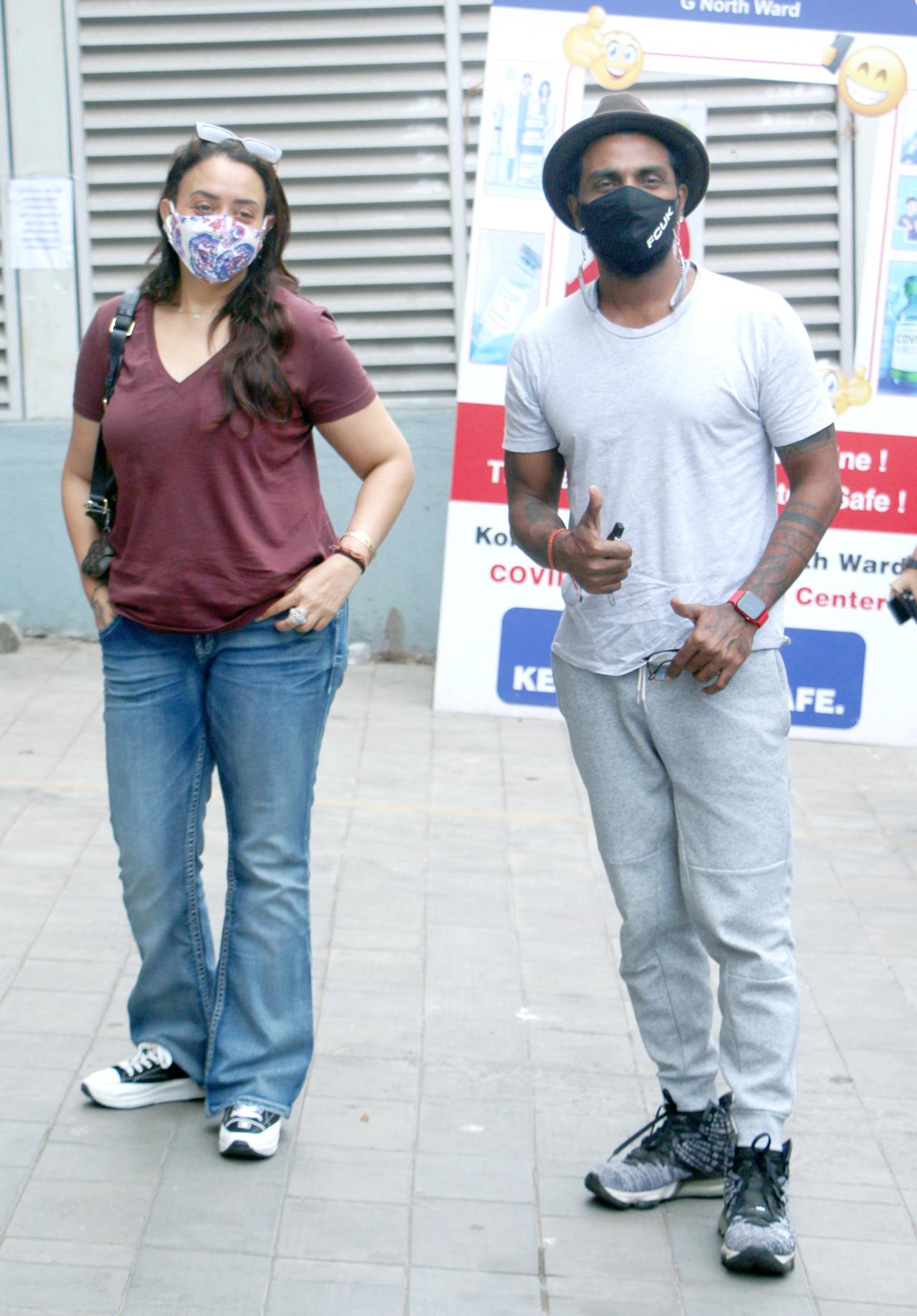 Remo D'Souza was clicked with his wife, Lizelle D'Souza outside the Covid-19 vaccination centre in Mumbai. The choreographer-director was all smiles for the paparazzi as he posed for few pictures, before making his way to the vaccine centre.