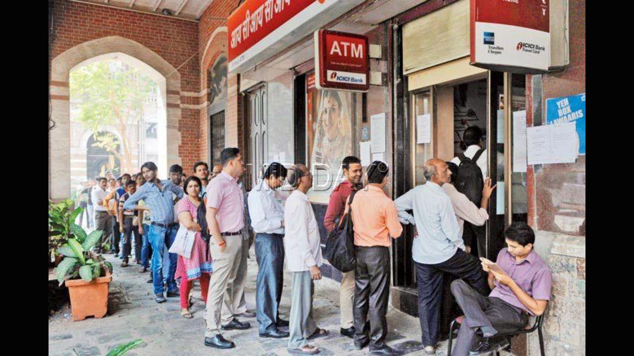 A week after demonetisation was announced on November 8 in 2016, people queue up outside an ATM at Fort to withdraw money. Photo: Mid-day file pic/Datta Kumbhar